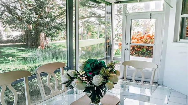 a view of a porch with chairs and backyard