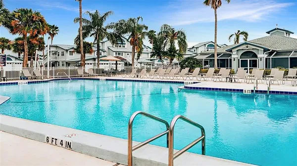a backyard of a house with lots of green space and glass table and chairs