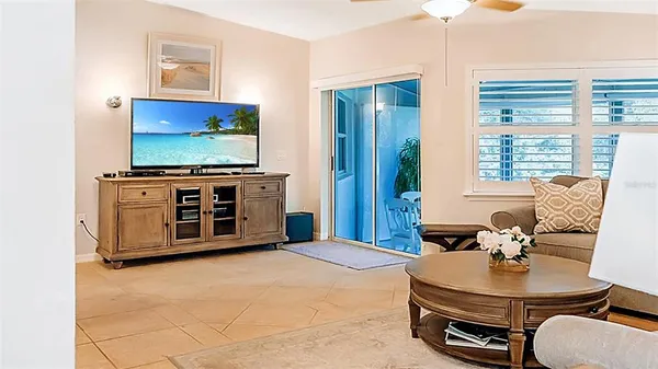 a living room with furniture and a dining table with kitchen view