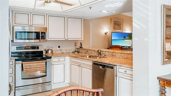 a kitchen with stainless steel appliances a refrigerator sink and cabinets