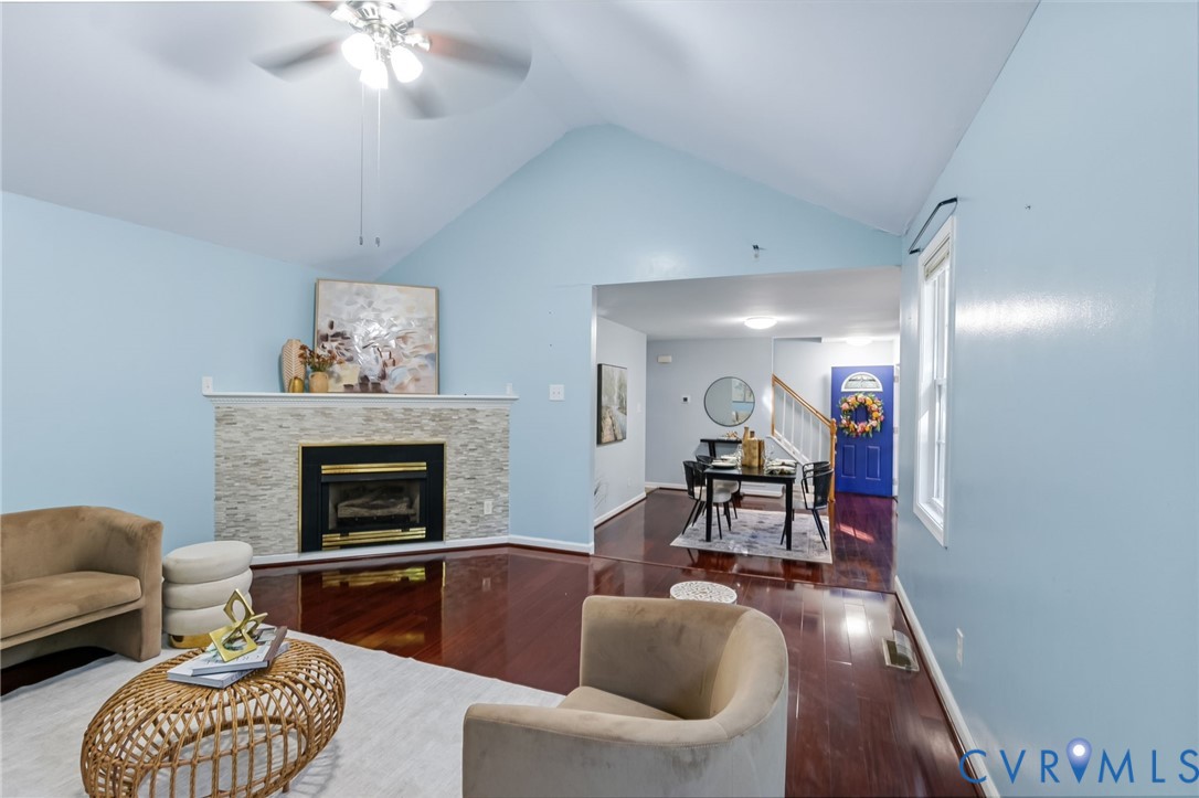 Vaulted ceiling with a ceiling fan, fireplace with
