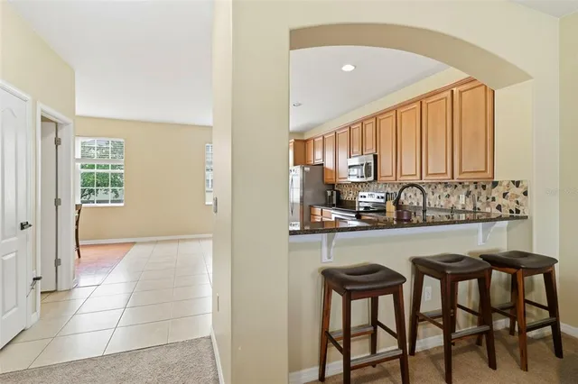a kitchen with a table chairs stove and cabinets