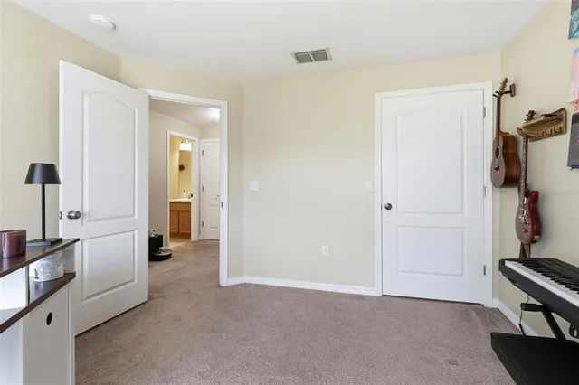 a view of a kitchen with refrigerator and a stove