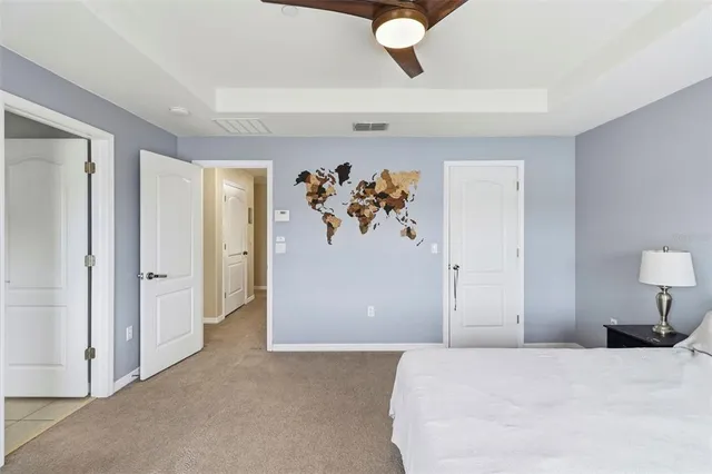 a bedroom with a bed and a painting on the wall