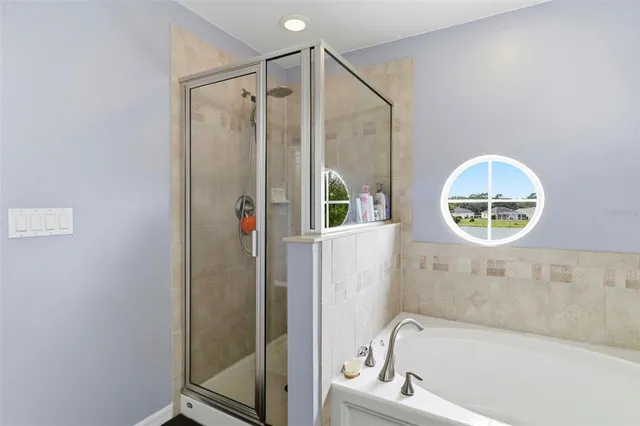 a bathroom with a bathtub and a shower