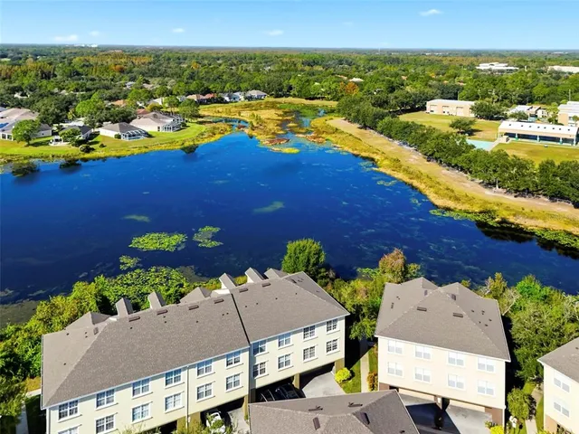 an aerial view of a house with a yard basket ball court and outdoor seating