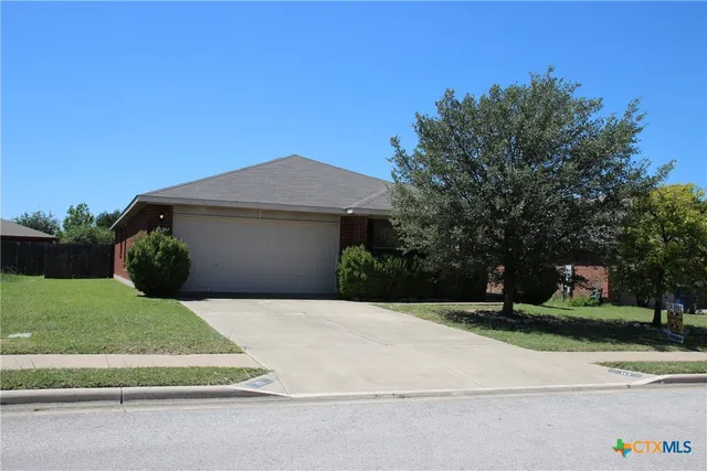 a front view of a house with a yard garage and outdoor seating