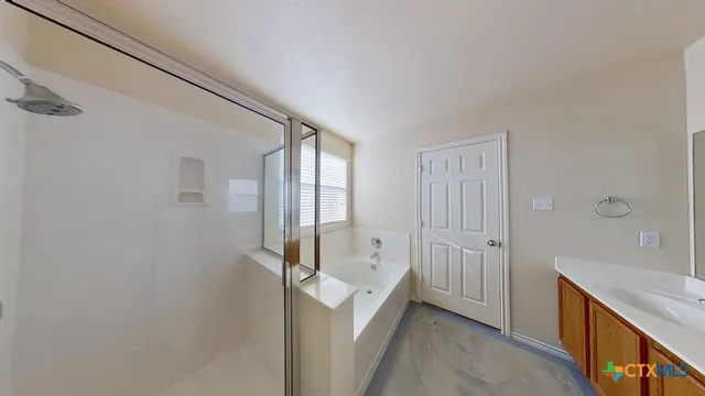 a view of a livingroom with a chandelier fan and windows