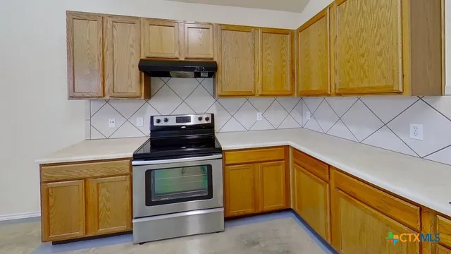 a kitchen with a stove and a microwave