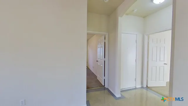 an empty room with windows and closet