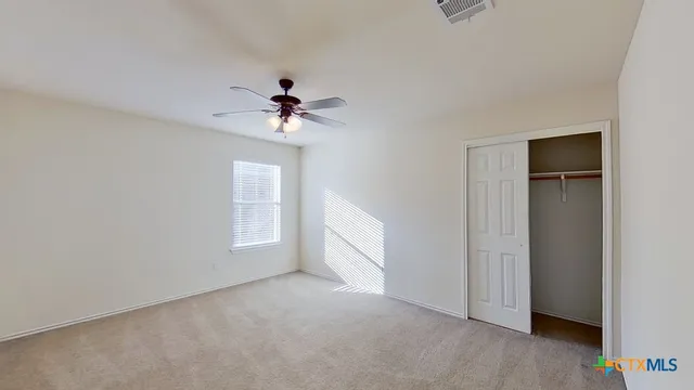 a view of a chandelier fan and closet in a room