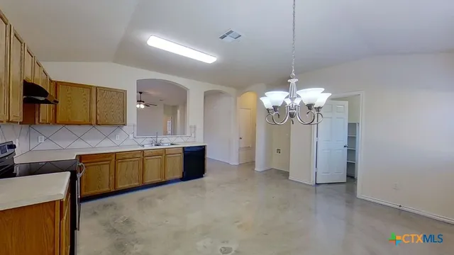 a large kitchen with lot of cabinets and stainless steel appliances