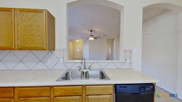 a kitchen with a sink cabinets and a granite counter top