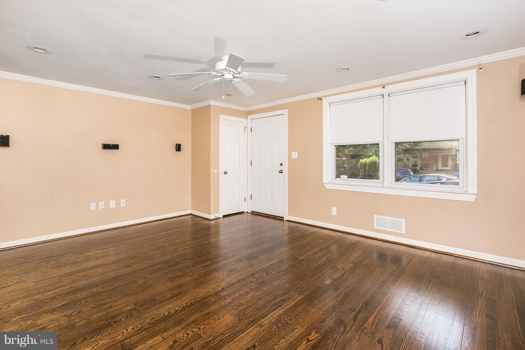 2802 Topaz Road Baltimore, MD 21234 - Photo 3 of 15 an empty room with wooden floor chandelier fan and windows