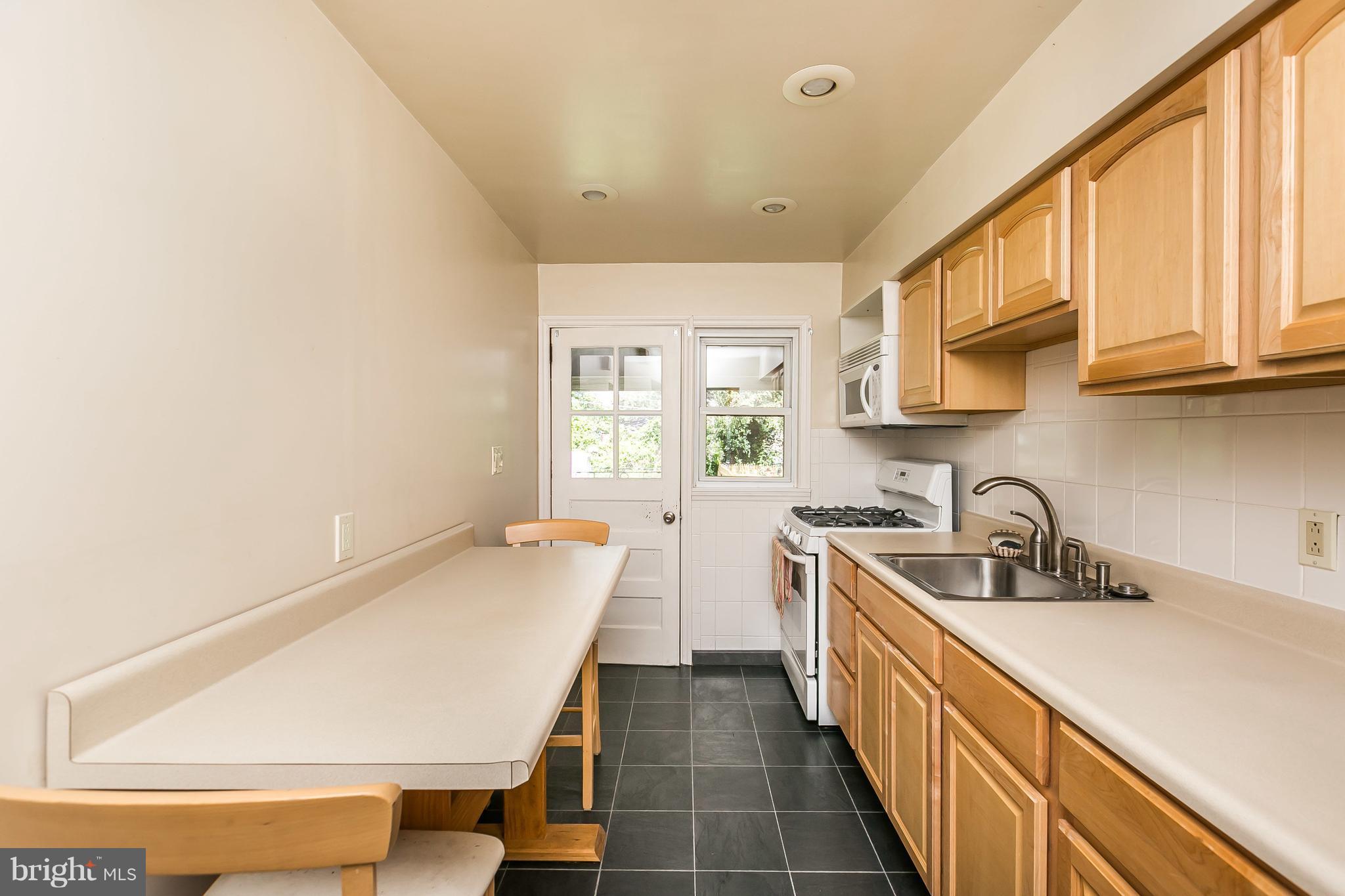 2802 Topaz Road Baltimore, MD 21234 - Photo 6 of 15 a kitchen with sink a window and stainless steel appliances