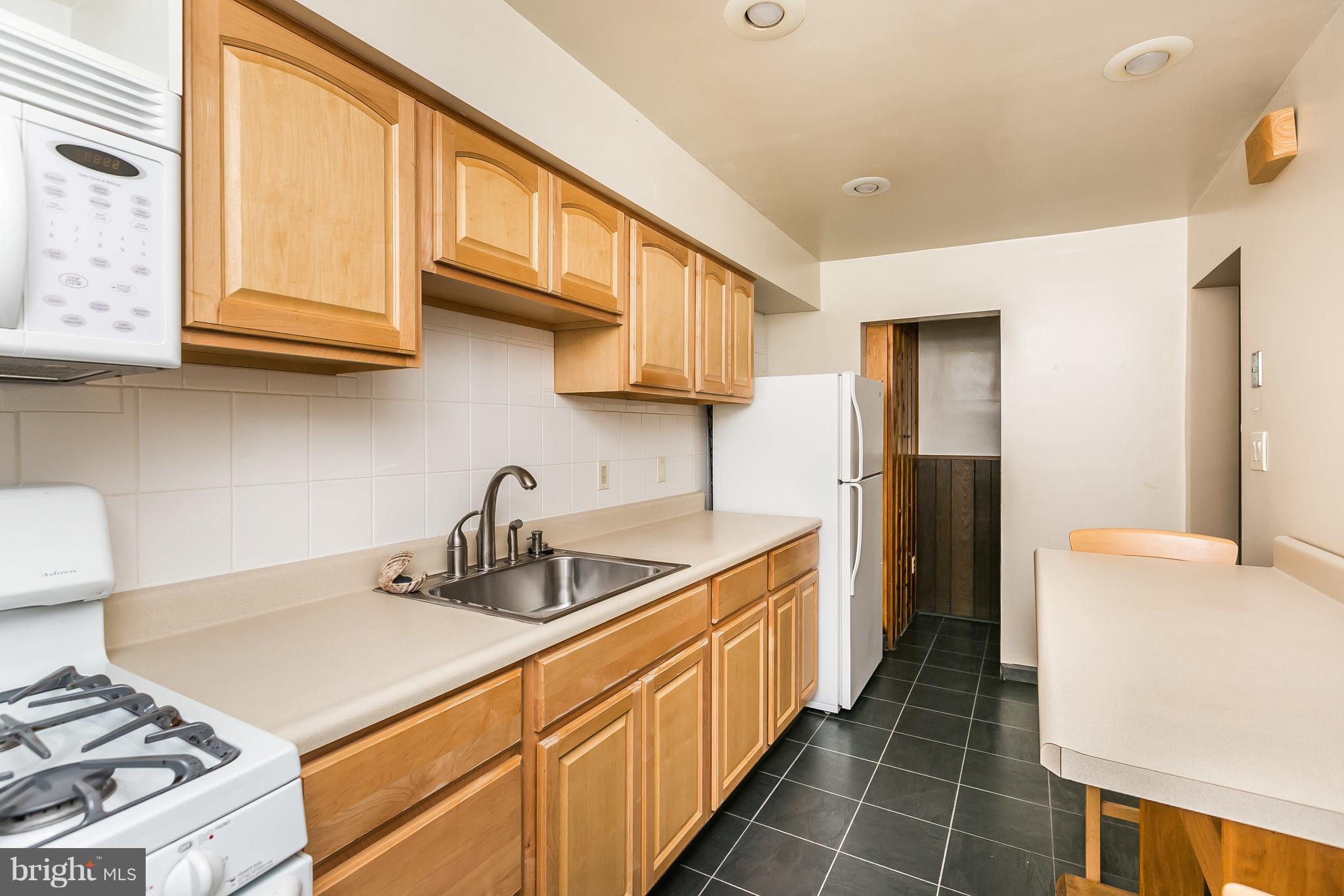 2802 Topaz Road Baltimore, MD 21234 - Photo 7 of 15 a kitchen with stainless steel appliances granite countertop a sink and a stove