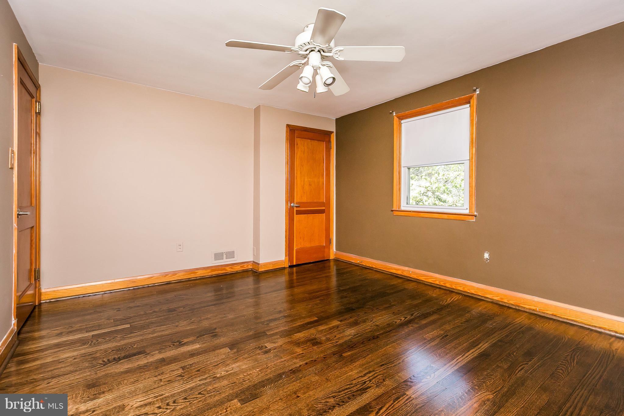 2802 Topaz Road Baltimore, MD 21234 - Photo 9 of 15 a view of an empty room with window and wooden floor