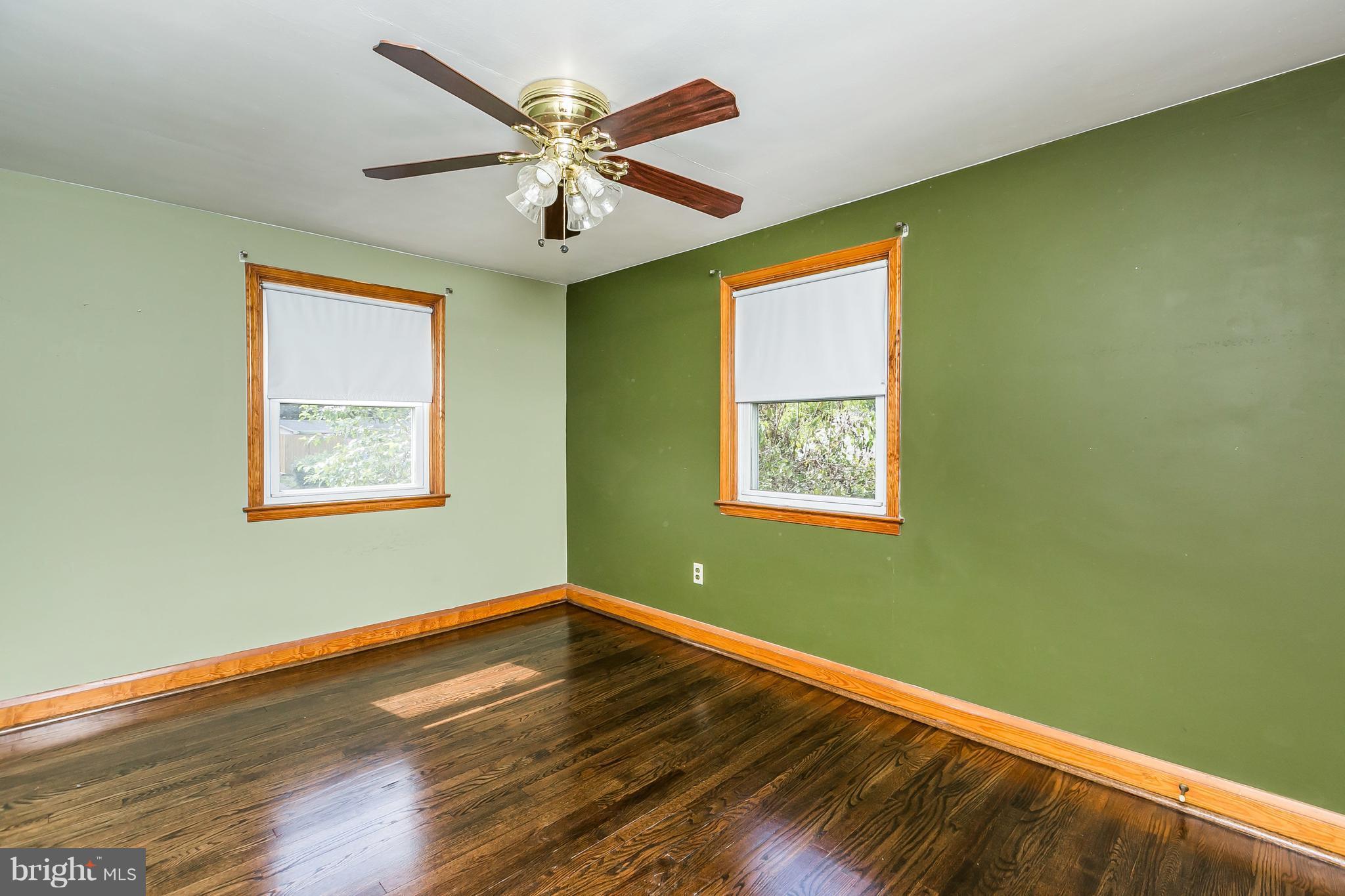 2802 Topaz Road Baltimore, MD 21234 - Photo 10 of 15 a view of a room with wooden floor a ceiling fan and a window