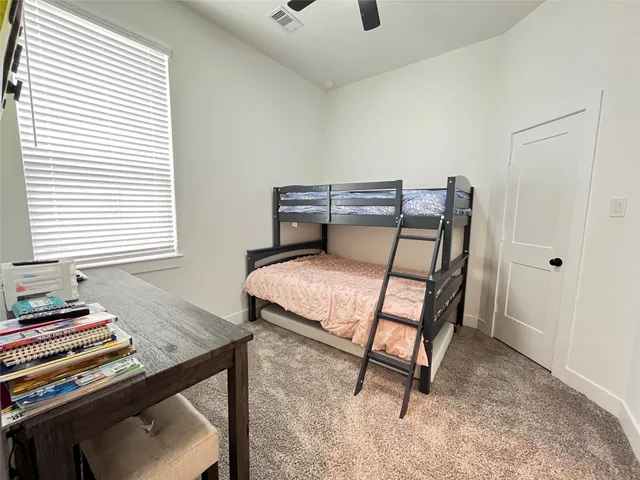 a bedroom with furniture and a window
