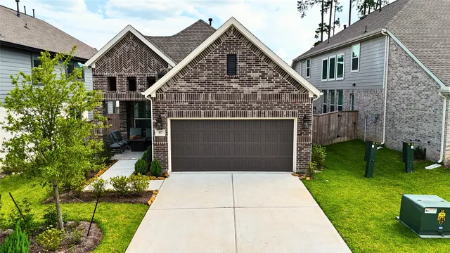 a front view of a house with a garden and yard