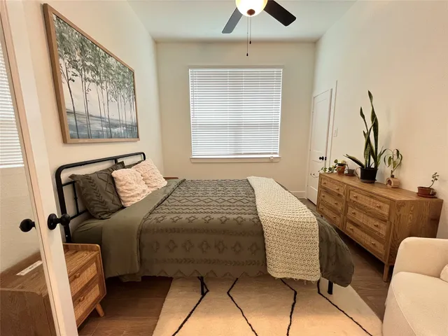 a bedroom with a bed and wooden floor