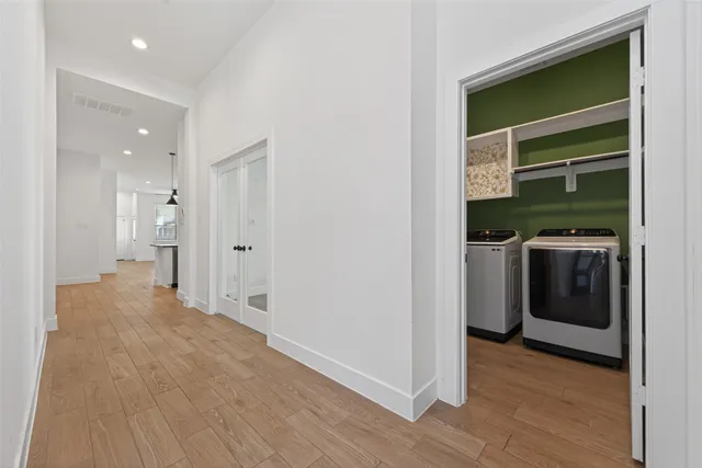 a view of an empty room and chandelier fan