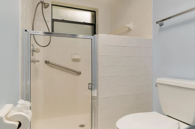 a bathroom with a toilet and a shower