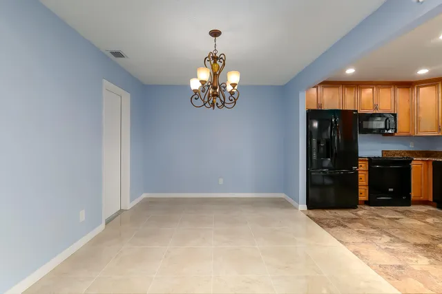 a view of a kitchen with wooden floor and a window