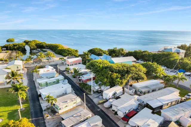 an aerial view of a houses with a lake view