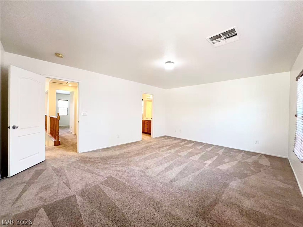 11143 Ranch Valley Street Las Vegas, NV 89179 - Photo 14 of 23 A spacious, naturally illuminated room featuring plush carpeting and neutral tones throughout.