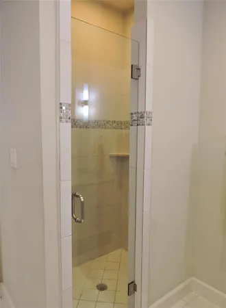 a bathroom with a glass shower door