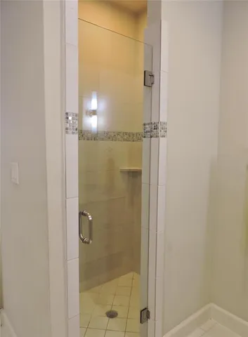 a bathroom with a glass shower door