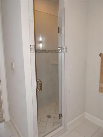 a bathroom with a glass shower door
