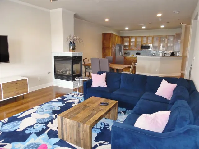 a living room with furniture and a wooden floor