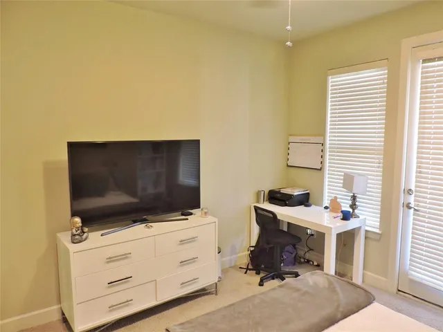 a room with furniture and flat screen tv