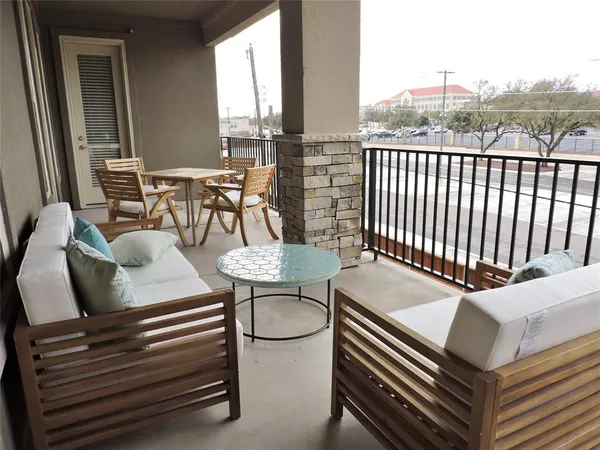 a outdoor sitting area with furniture and wooden floor