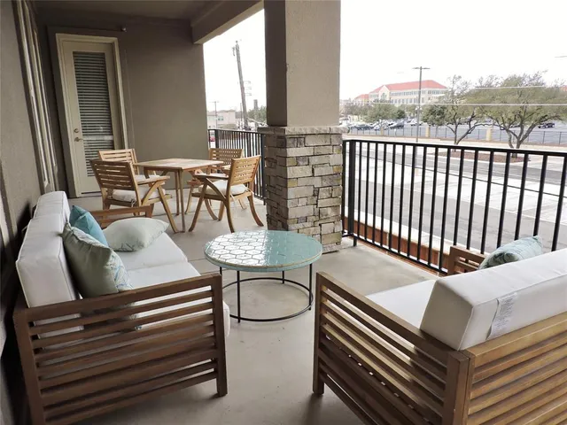 a outdoor sitting area with furniture and wooden floor