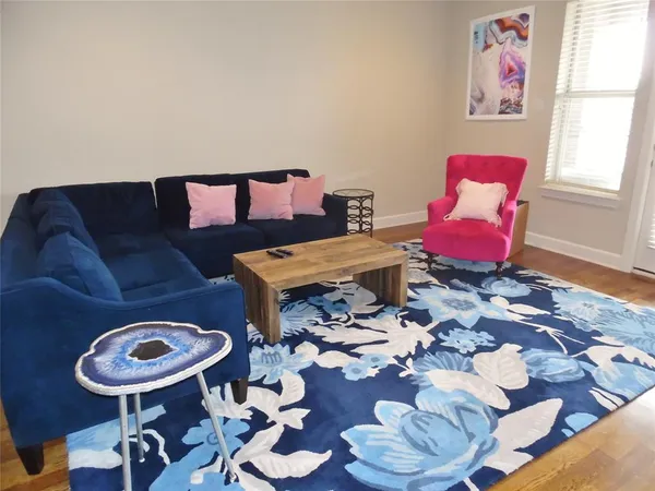 a living room with furniture and a rug
