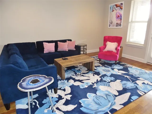 a living room with furniture and a rug