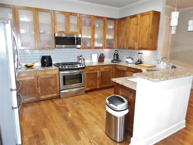 a kitchen with a stove a sink and a refrigerator