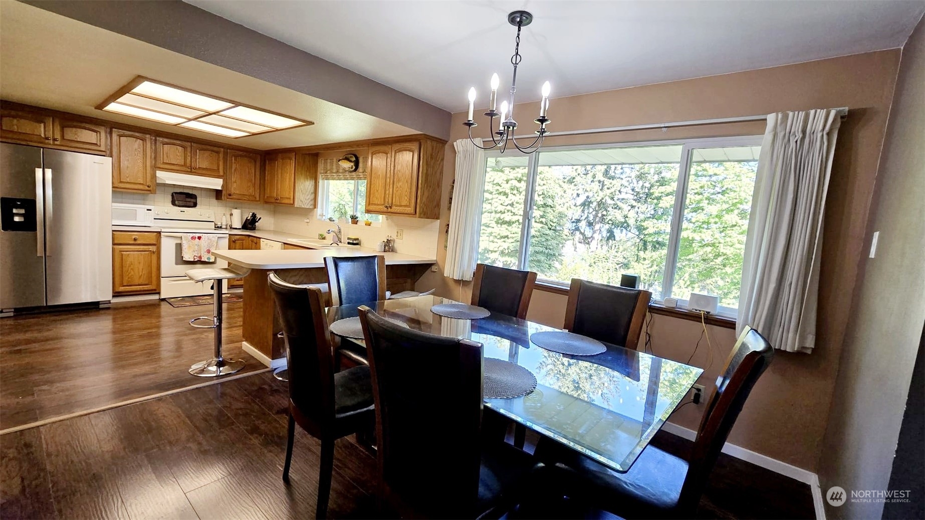 4403 Thomson Avenue Everett, WA 98203 - Photo 7 of 18 a view of a dining room with furniture window and wooden floor