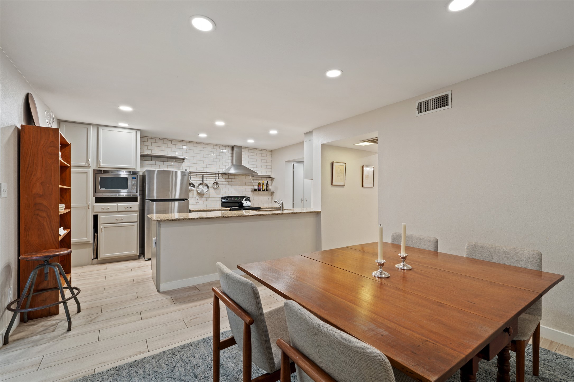 3467 North Hills Drive Austin, TX 78731 - Photo 18 of 40 a kitchen with a table chairs refrigerator and cabinets