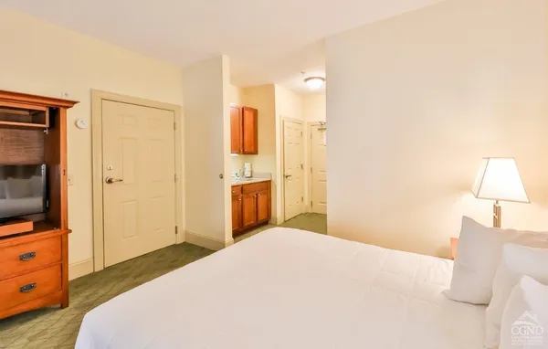 a bedroom with a bed and a flat screen tv
