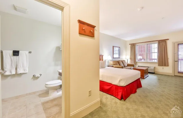 a spacious bedroom with a bed and a couch