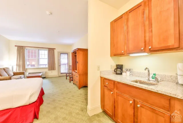 a kitchen with stainless steel appliances granite countertop a sink dishwasher and cabinets with wooden floor