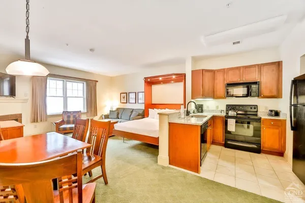 a large kitchen with a table and chairs