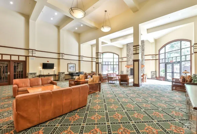 a living room with furniture fireplace and a large window