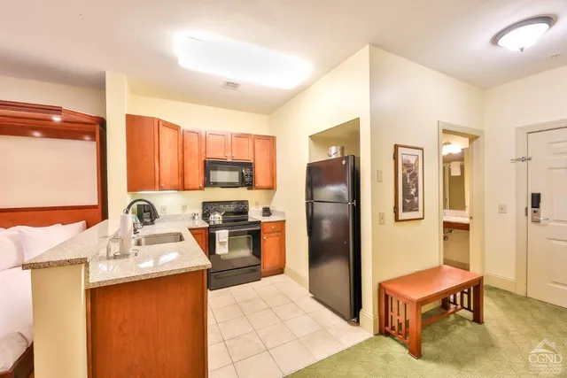a kitchen with stainless steel appliances a refrigerator sink and stove