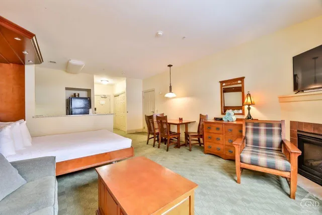 a living room with furniture a dining table and chairs with wooden floor