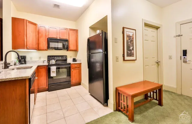a kitchen with stainless steel appliances a refrigerator and a stove top oven